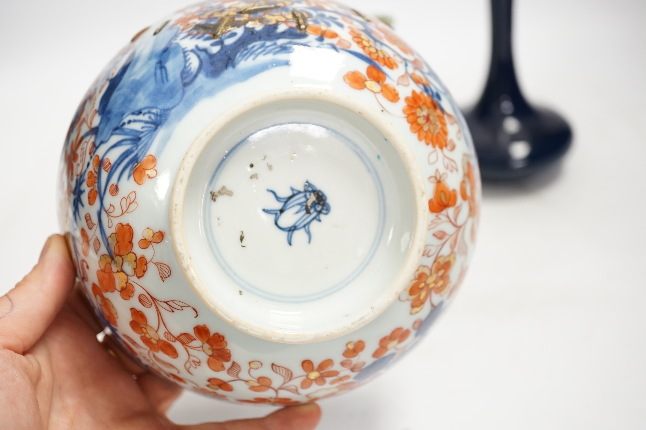 A Chinese famille rose bowl, an Imari patterned bowl, a small blue glazed vase and a similar celadon glazed vase, 18th century and later. Condition - both bowls badly cracked, overall poor